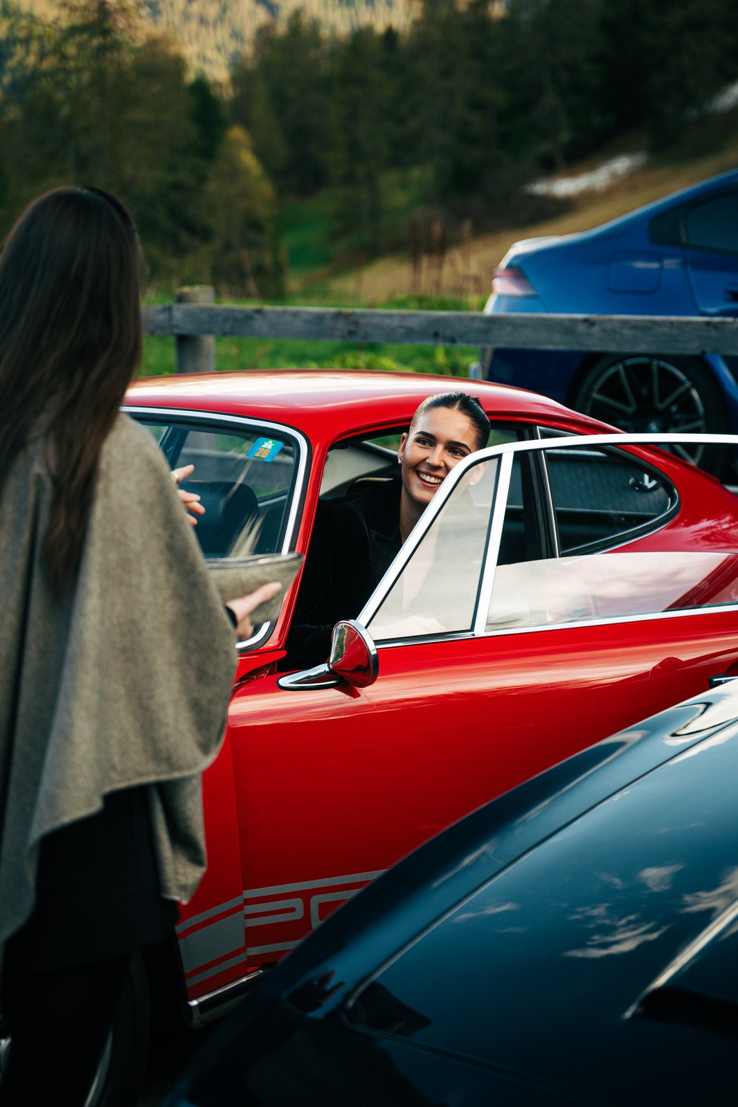 A guest in a classic red Porsche